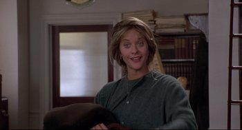 Movie still from “Sleepless in Seattle” (1993), directed by Nora Ephron – A woman in grey sweater sitting in a room; Medium shot, Low angle
