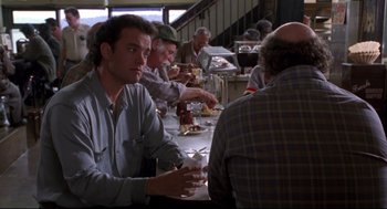 Movie still from “Sleepless in Seattle” (1993), directed by Nora Ephron – A group of people sitting at a table eating food; Medium shot, Over the shoulder angle