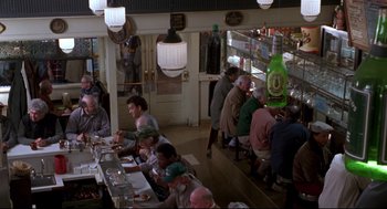 Movie still from “Sleepless in Seattle” (1993), directed by Nora Ephron – A group of people sitting at a table in a restaurant; Wide shot, High angle