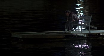 Movie still from “Sleepless in Seattle” (1993), directed by Nora Ephron – A man sitting on a dock in the water; Wide shot, High angle