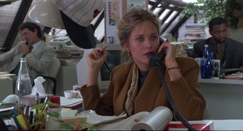 Movie still from “Sleepless in Seattle” (1993), directed by Nora Ephron – A woman sitting at a table talking on a phone; Medium shot, High angle