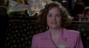 Movie still from “Sleepless in Seattle” (1993), directed by Nora Ephron – A person with curly hair wearing a pink jacket; Close Up shot, Over the shoulder angle