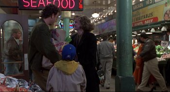 Movie still from “Sleepless in Seattle” (1993), directed by Nora Ephron – A group of people standing around in a store; Wide shot, Over the shoulder angle