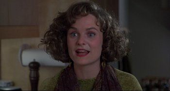 Movie still from “Sleepless in Seattle” (1993), directed by Nora Ephron – A person with curly hair wearing a scarf; Close Up shot, Over the shoulder angle