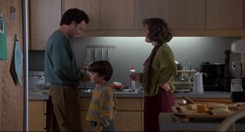 Movie still from “Sleepless in Seattle” (1993), directed by Nora Ephron – Two people and a child standing in a kitchen; Medium shot, Low angle