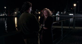 Movie still from “Sleepless in Seattle” (1993), directed by Nora Ephron – Two people standing next to a railing at night; Medium shot, Over the shoulder angle