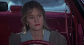 Movie still from “Sleepless in Seattle” (1993), directed by Nora Ephron – A woman sitting in the driver's seat of a car; Close Up shot, Over the shoulder angle