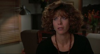 Movie still from “Sleepless in Seattle” (1993), directed by Nora Ephron – A person with curly hair wearing a necklace; Close Up shot, Over the shoulder angle