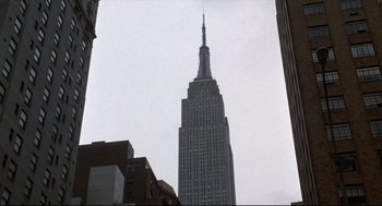 Movie still from “Sleepless in Seattle” (1993), directed by Nora Ephron – A very tall building in the middle of a city; Extreme Wide shot, Low angle
