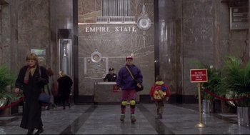 Movie still from “Sleepless in Seattle” (1993), directed by Nora Ephron – A man and a child in a lobby of an empire state building; Wide shot, Low angle