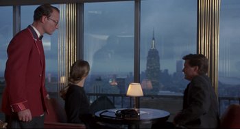 Movie still from “Sleepless in Seattle” (1993), directed by Nora Ephron – A group of people sitting at a table in front of a window; Medium shot, Over the shoulder angle