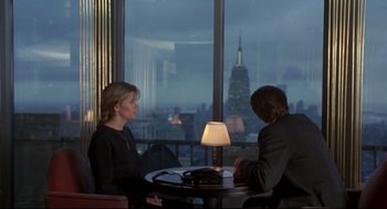 Movie still from “Sleepless in Seattle” (1993), directed by Nora Ephron – A man and a woman sitting at a table in front of a window; Medium shot, Over the shoulder angle