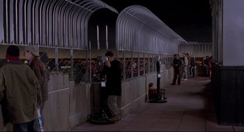 Movie still from “Sleepless in Seattle” (1993), directed by Nora Ephron – A man standing in front of a phone booth; Wide shot, High angle