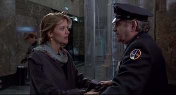 Movie still from “Sleepless in Seattle” (1993), directed by Nora Ephron – A woman and a police officer talking to each other; Medium shot, Over the shoulder angle
