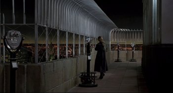 Movie still from “Sleepless in Seattle” (1993), directed by Nora Ephron – A woman standing next to a parking meter at night; Extreme Wide shot, High angle