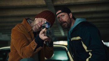 Movie still from “Sniper: Rogue Mission” (2022), directed by Oliver Thompson – Two men looking at something in the distance; Medium shot, Low angle