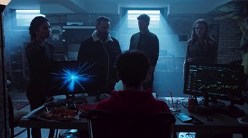 Movie still from “Sniper: Rogue Mission” (2022), directed by Oliver Thompson – A group of people standing around a table; Wide shot, Over the shoulder angle