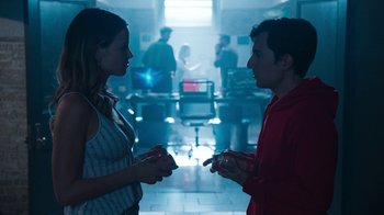 Movie still from “Sniper: Rogue Mission” (2022), directed by Oliver Thompson – A man and a woman are talking to each other; Medium shot, Over the shoulder angle