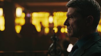 Movie still from “Sniper: Rogue Mission” (2022), directed by Oliver Thompson – A person looking at something; Close Up shot, Low angle