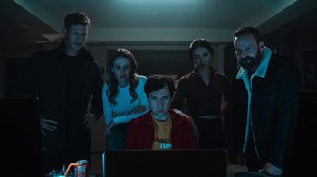 Movie still from “Sniper: Rogue Mission” (2022), directed by Oliver Thompson – A group of people standing in front of a computer; Medium shot, Low angle