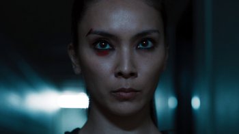 Movie still from “Sniper: Rogue Mission” (2022), directed by Oliver Thompson – A person with a bruise on their face; Close Up shot, Low angle