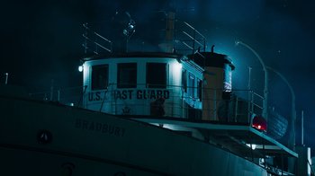 Movie still from “Sniper: Rogue Mission” (2022), directed by Oliver Thompson – A boat is lit up at night in the dark; Extreme Wide shot, Low angle