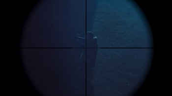 Movie still from “Sniper: Rogue Mission” (2022), directed by Oliver Thompson – A view of a person in the water through a scope; Extreme Close Up shot, Overhead angle