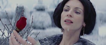 Movie still from “Snow White and the Huntsman” (2012), directed by Rupert Sanders – A woman in a fur coat holding a branch; Close Up shot, Low angle