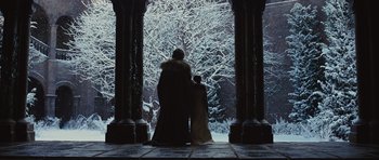 Movie still from “Snow White and the Huntsman” (2012), directed by Rupert Sanders – Two people standing next to each other in front of snow covered trees; Wide shot, Low angle