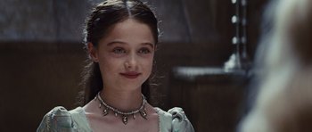 Movie still from “Snow White and the Huntsman” (2012), directed by Rupert Sanders – A young girl wearing a necklace with skulls on it; Close Up shot, Over the shoulder angle