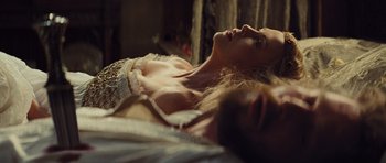 Movie still from “Snow White and the Huntsman” (2012), directed by Rupert Sanders – A woman laying on top of a bed next to another woman; Close Up shot, Low angle