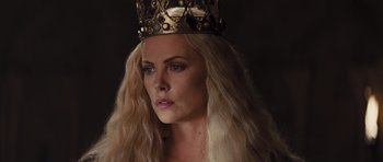 Movie still from “Snow White and the Huntsman” (2012), directed by Rupert Sanders – A woman with long blonde hair wearing a gold crown; Close Up shot, Low angle