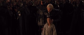 Movie still from “Snow White and the Huntsman” (2012), directed by Rupert Sanders – A woman and a child in medieval garb in front of a group of people; Medium shot, Over the shoulder angle