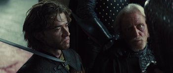 Movie still from “Snow White and the Huntsman” (2012), directed by Rupert Sanders – A person wearing a suit of armor; Close Up shot, Over the shoulder angle