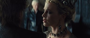 Movie still from “Snow White and the Huntsman” (2012), directed by Rupert Sanders – A person wearing a necklace; Close Up shot, Over the shoulder angle
