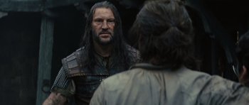 Movie still from “Snow White and the Huntsman” (2012), directed by Rupert Sanders – A man with long hair is looking at himself in the mirror; Close Up shot, Over the shoulder angle