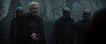 Movie still from “Snow White and the Huntsman” (2012), directed by Rupert Sanders – A group of people in costume standing in the woods; Medium shot, Over the shoulder angle