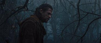 Movie still from “Snow White and the Huntsman” (2012), directed by Rupert Sanders – A man in a brown jacket standing next to a tree; Close Up shot, Low angle