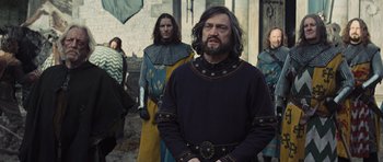 Movie still from “Snow White and the Huntsman” (2012), directed by Rupert Sanders – A group of men standing next to each other; Medium shot, Over the shoulder angle