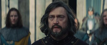 Movie still from “Snow White and the Huntsman” (2012), directed by Rupert Sanders – A person with long grey hair; Close Up shot, Over the shoulder angle
