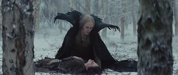 Movie still from “Snow White and the Huntsman” (2012), directed by Rupert Sanders – A woman in a black dress and a man in a black coat; Medium shot, Low angle