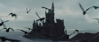 Movie still from “Snow White and the Huntsman” (2012), directed by Rupert Sanders – A flock of birds flying around a castle; Extreme Wide shot, Low angle