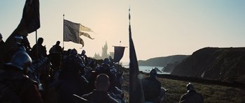 Movie still from “Snow White and the Huntsman” (2012), directed by Rupert Sanders – A group of people sitting on top of a beach; Extreme Wide shot, Low angle
