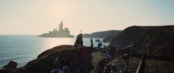 Movie still from “Snow White and the Huntsman” (2012), directed by Rupert Sanders – A group of people sitting on top of a sandy beach; Extreme Wide shot, Low angle