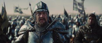Movie still from “Snow White and the Huntsman” (2012), directed by Rupert Sanders – A person wearing a metal helmet; Close Up shot, Low angle