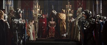 Movie still from “Snow White and the Huntsman” (2012), directed by Rupert Sanders – A scene from a medieval play with a woman being crowned by a king; Wide shot, High angle