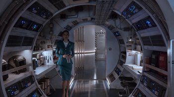 Movie still from “Snowpiercer” (2020), created by Graeme Manson – A woman standing in front of an open door; Wide shot, Over the shoulder angle