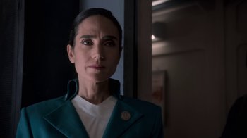 Movie still from “Snowpiercer” (2020), created by Graeme Manson – A woman wearing a green jacket and a white shirt; Close Up shot, Low angle