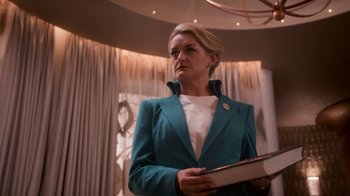 Movie still from “Snowpiercer” (2020), created by Graeme Manson – A woman in a blue jacket holding a book in her hands; Medium shot, Low angle