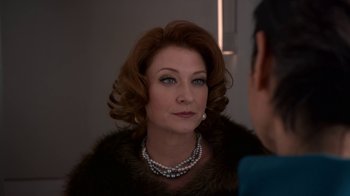 Movie still from “Snowpiercer” (2020), created by Graeme Manson – A person wearing a necklace; Close Up shot, Over the shoulder angle